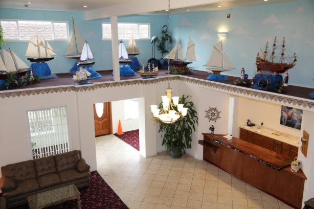 a living room with model boats on the wall at Oceanview Inn and Suites in Crescent City