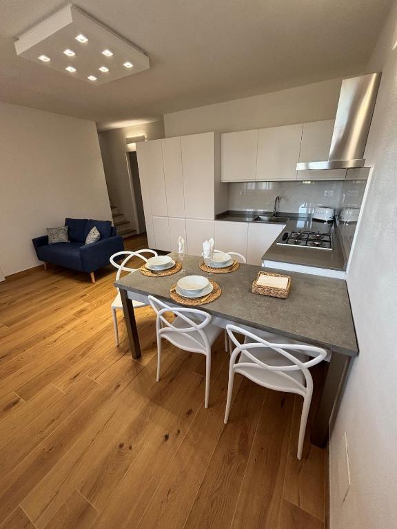 a kitchen and living room with a table and chairs at Mugello Circuit & Florence charm in Scarperia