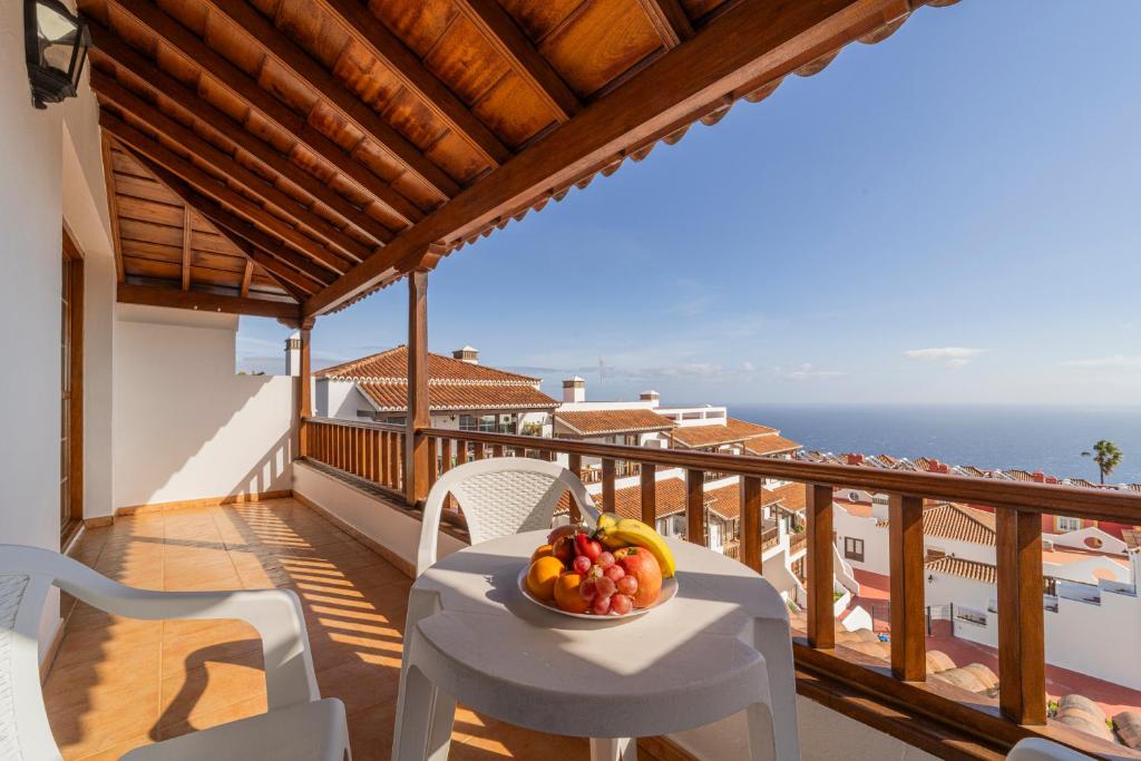 a bowl of fruit on a table on a balcony at CHL Serycam Breña Baja, infinity views in Breña Baja