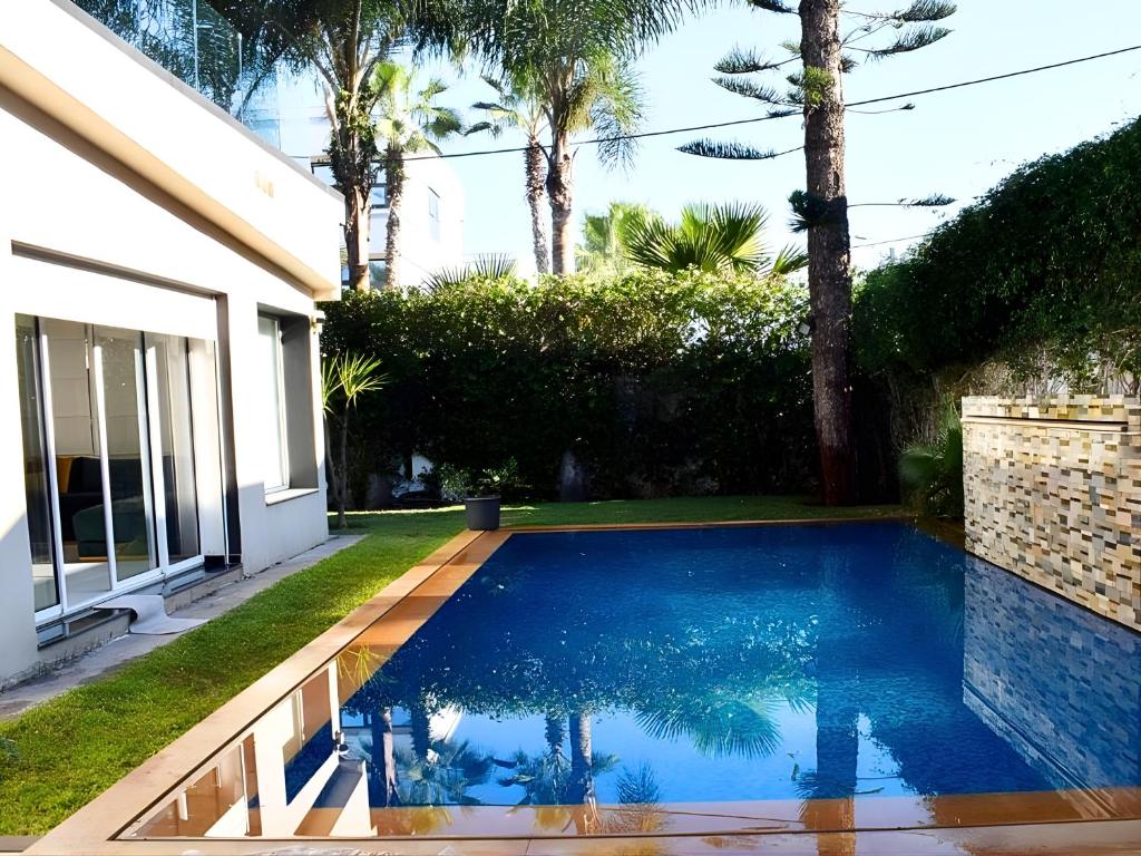 a swimming pool in the backyard of a house at Villa Les Ambassades in Kenitra