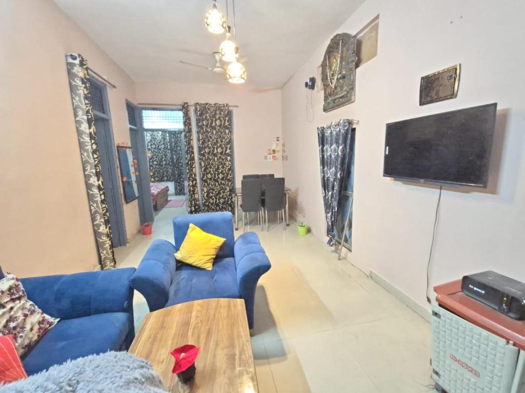 a living room with a blue couch and a table at Vishwanathan in Varanasi