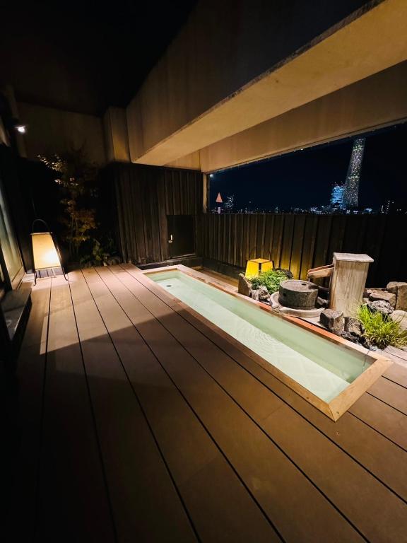 a swimming pool in a backyard at night at Dormy Inn EXPRESS Asakusa in Tokyo