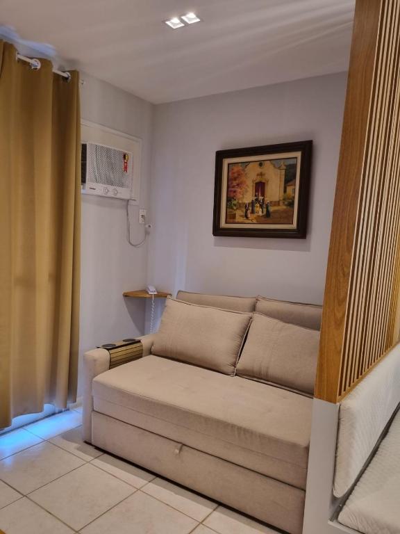 a living room with a couch in a room at Best Residence in Rio de Janeiro