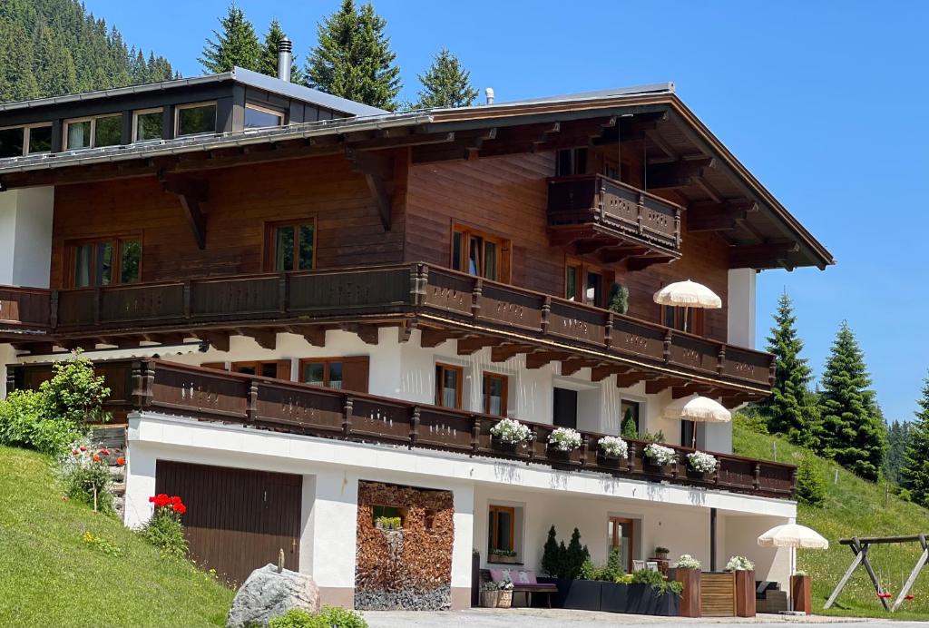 a large house with balconies on a mountain at Appartements Birkenhof in Lech am Arlberg