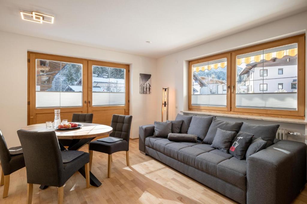 a living room with a couch and a table at Chalet Veronika in Fieberbrunn
