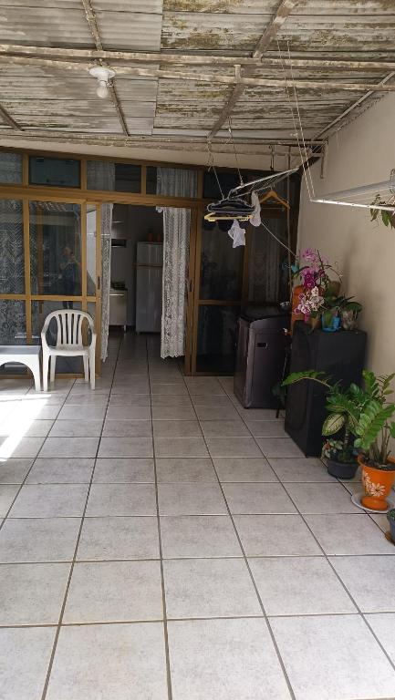 an outdoor patio with a table and a chair at Casa - BC in Balneário Camboriú