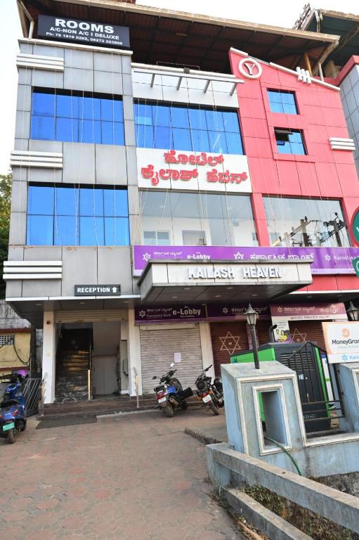 a building with motorcycles parked in front of it at Hotel Kailash Heaven in Madikeri