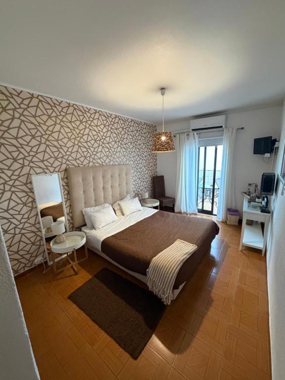 En eller flere senge i et værelse på Vivenda Rosa Lagos