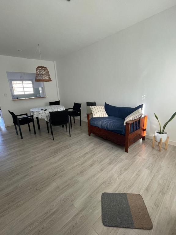 a living room with a couch and a table at Mansilla playa in Mar del Plata