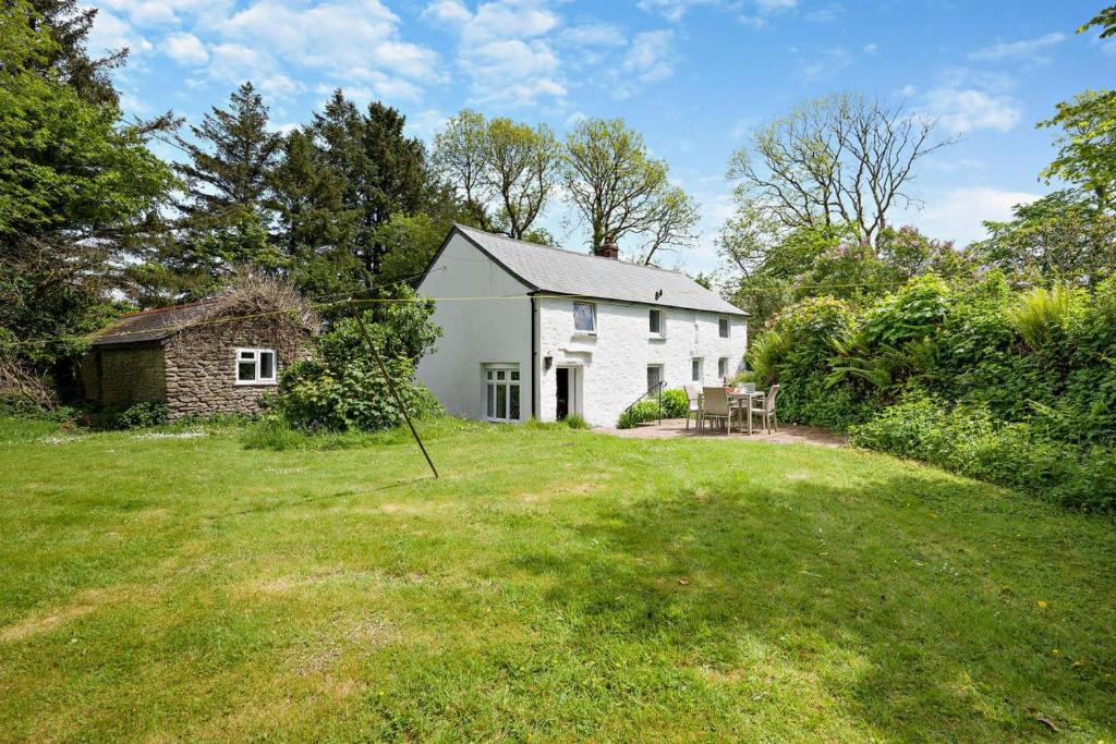 een wit huis met een tuin ervoor bij 2 Bed in Advent oc-s6025 in Camelford
