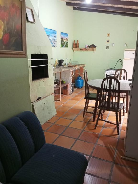 a kitchen and dining room with a table and chairs at Kitnet in Itapema