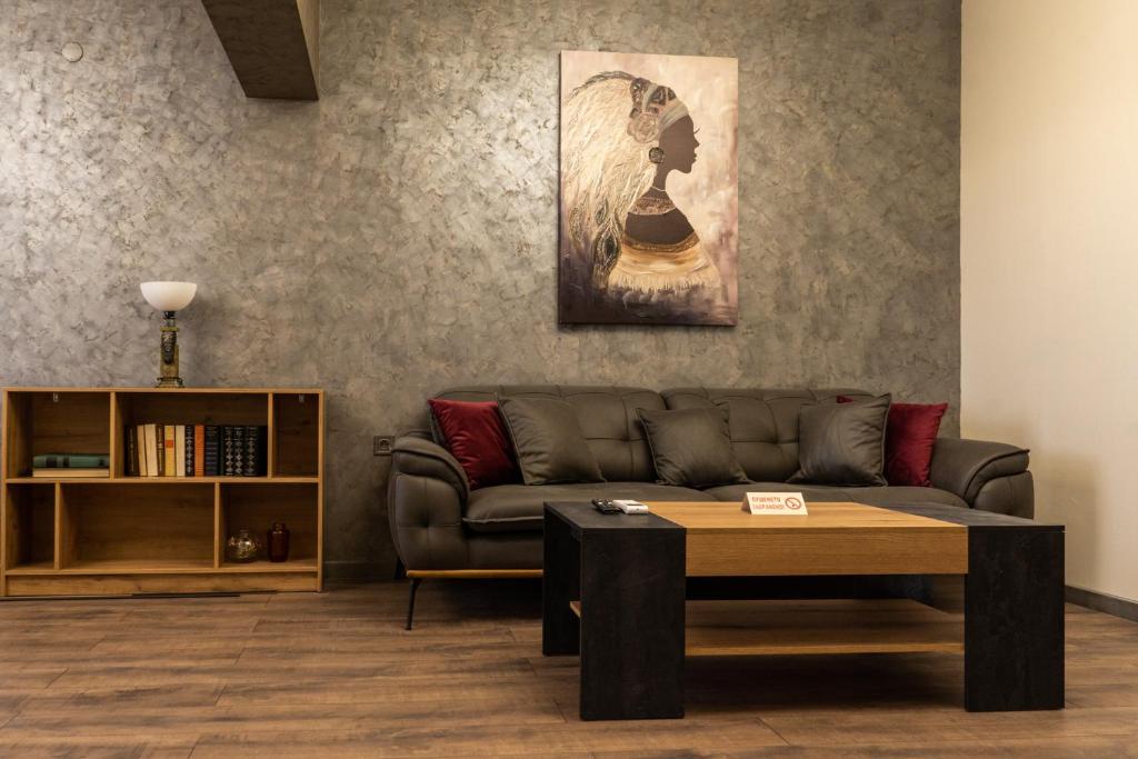 a living room with a couch and a table at Апартамент 8 in Lovech