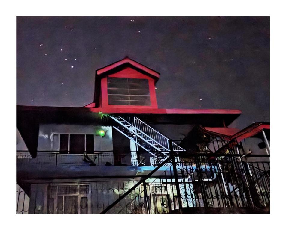 a building with a staircase on top of it at night at The Sunrise Retreat in Solan