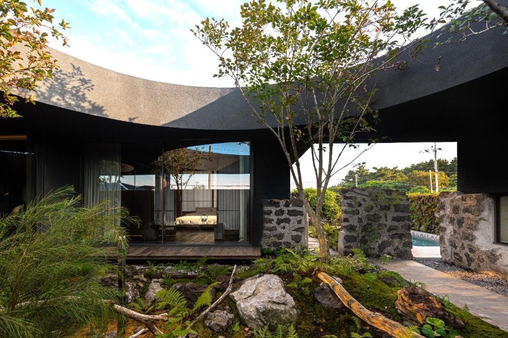 a modern house with a black roof at 제주 감성숙소 스테이보스케 in Jeju