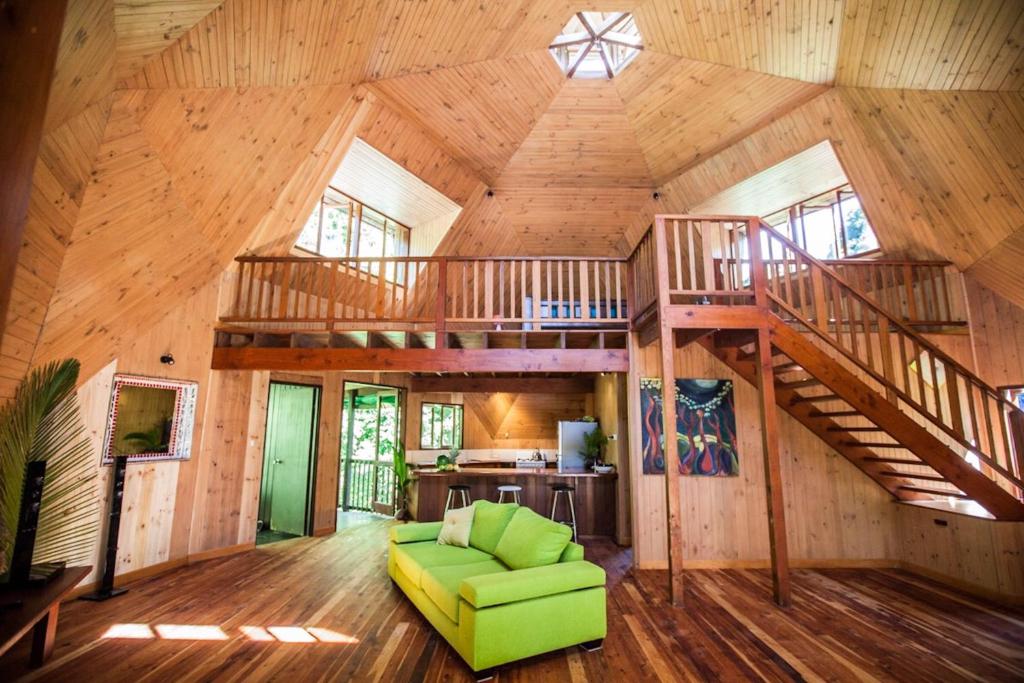 a large room with a staircase in a wooden house at Cape Tribulation Holiday House in Cape Tribulation