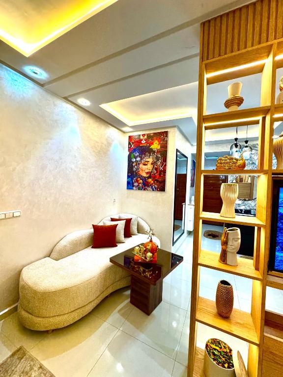 a living room with a couch and a table at Afalux Brand chic in Agadir