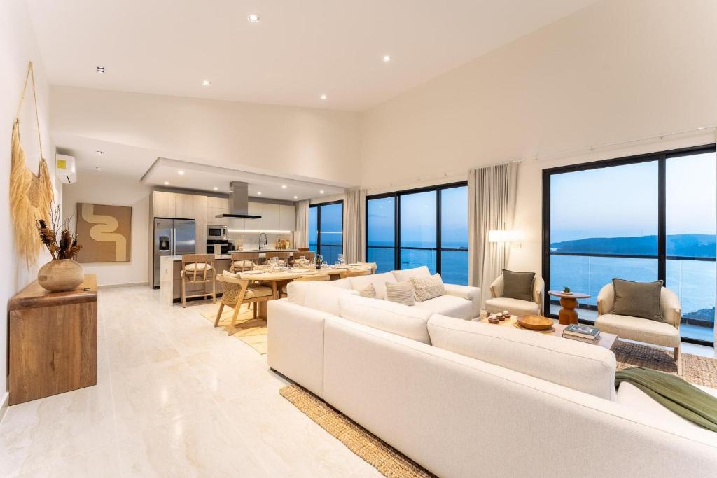 a living room with white furniture and large windows at 3082 - Paradise Cove 3A Manzanillo in Tangolunda