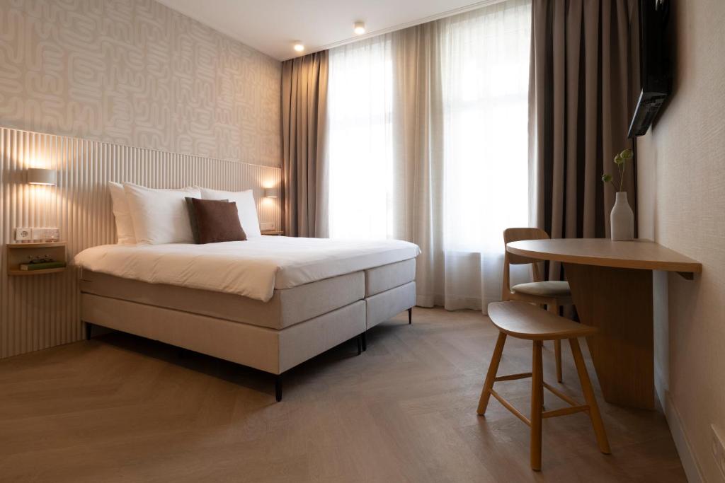Giường trong phòng chung tại Hotel Zest Den Haag - Scheveningen