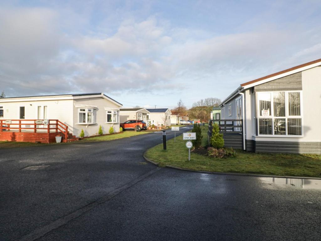 an empty street in front of a house at Beechtree Timber Lodge 69B in Denny