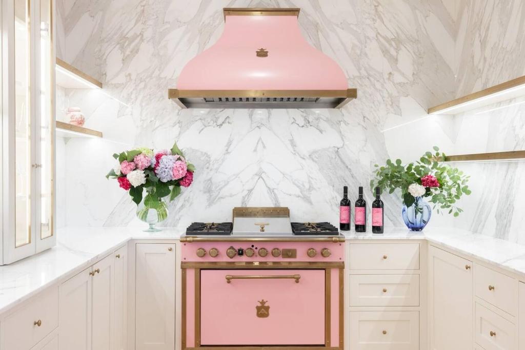 a kitchen with a pink stove and vases of flowers at Villa Sant 'Angelus in Canonica