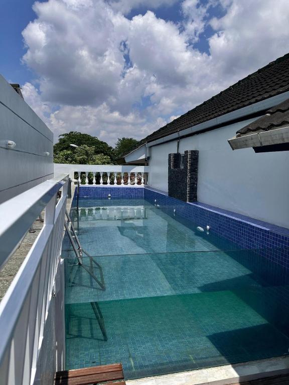 a swimming pool on the roof of a building at Omah Putih Jogja in Yogyakarta