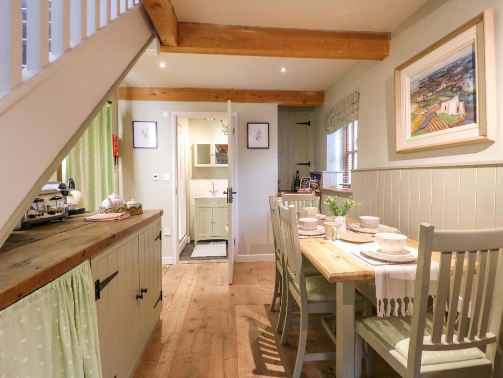 a kitchen and dining room with a table and chairs at The Hayloft - Beautiful Barn Stay in Ashford