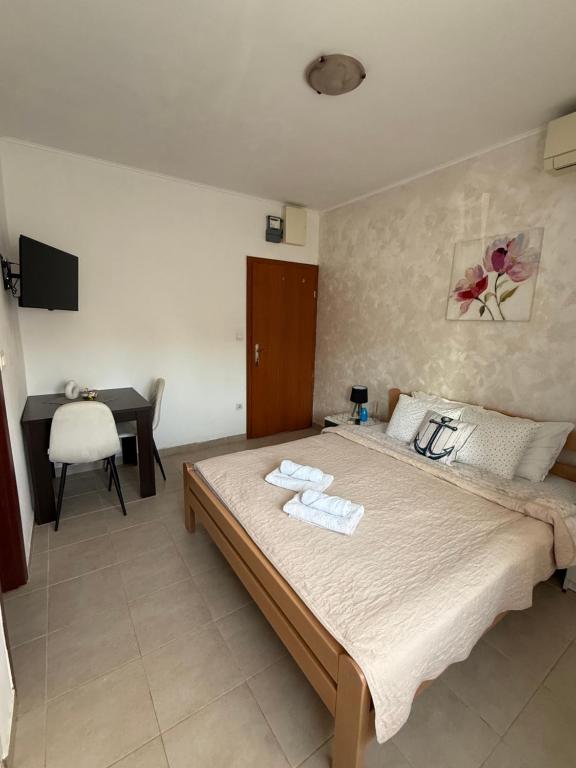 a bedroom with a bed with towels on it at Apartmani Marković in Tivat