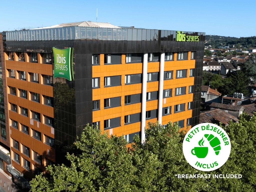 a building with two green signs on the side of it at ibis styles Albi Centre Le Theatro in Albi
