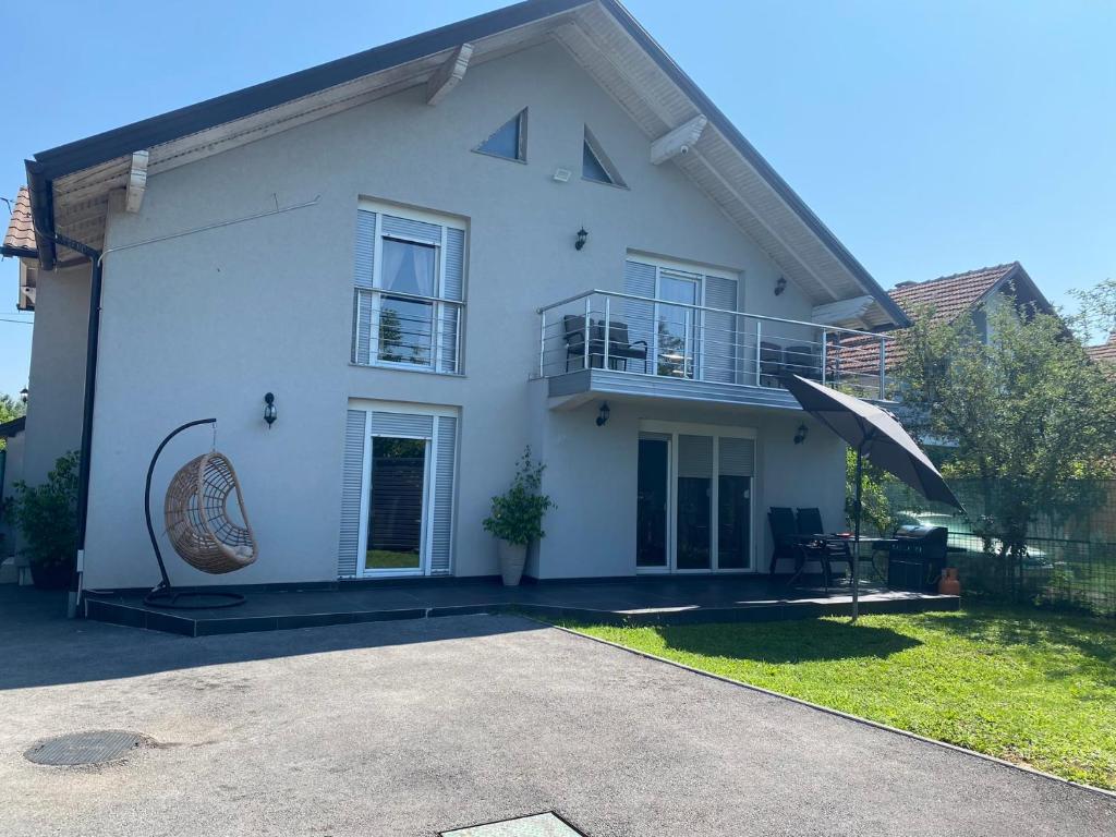 a white house with a balcony and a patio at Murat villa in SJJ