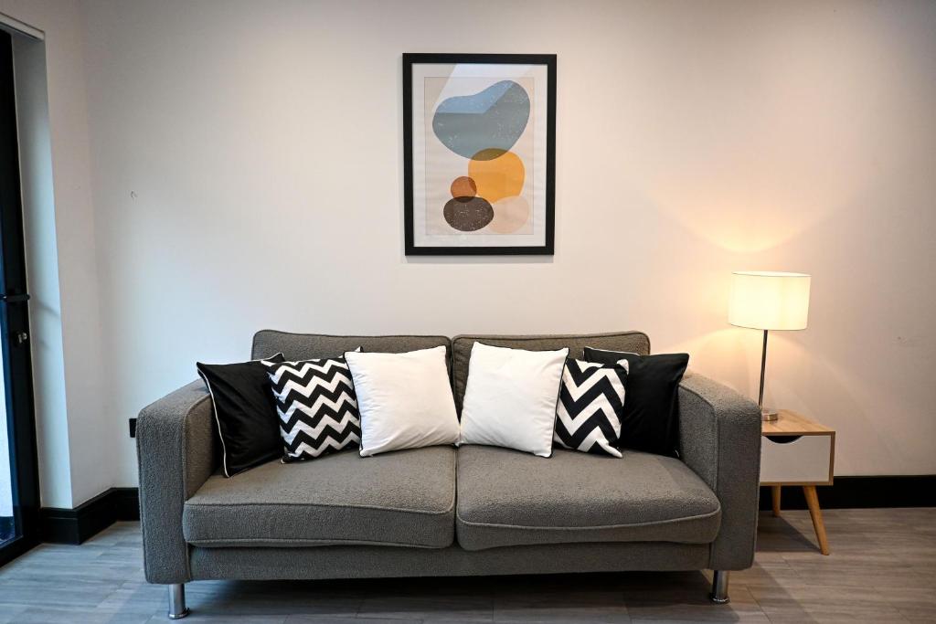 a living room with a couch with pillows on it at Laurie Grove in London