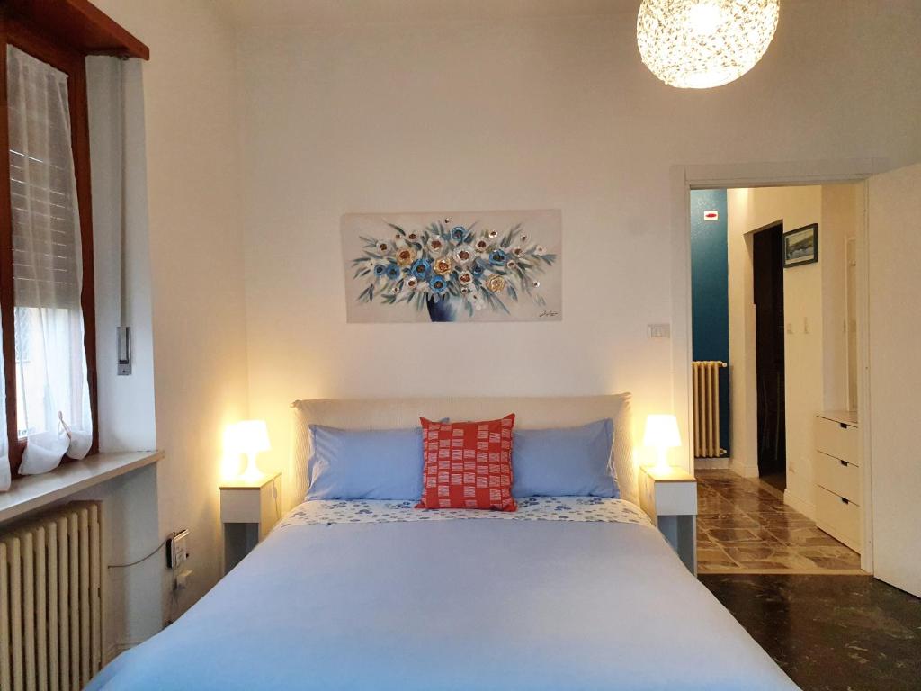 a bedroom with a large bed with a red pillow at Fiori e Frutti Guest Home in Almese