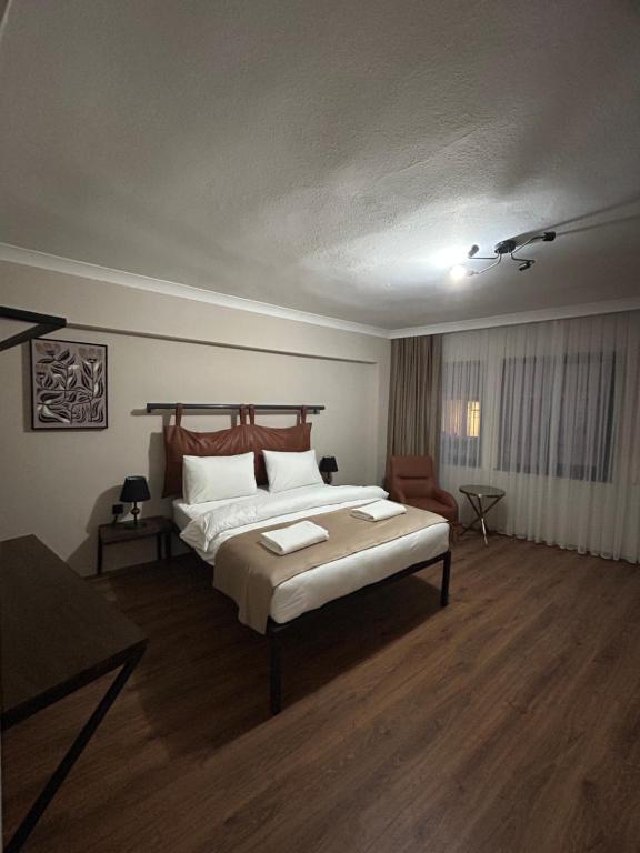 a bedroom with a large bed and a chair at Pera Line Yalova in Yalova