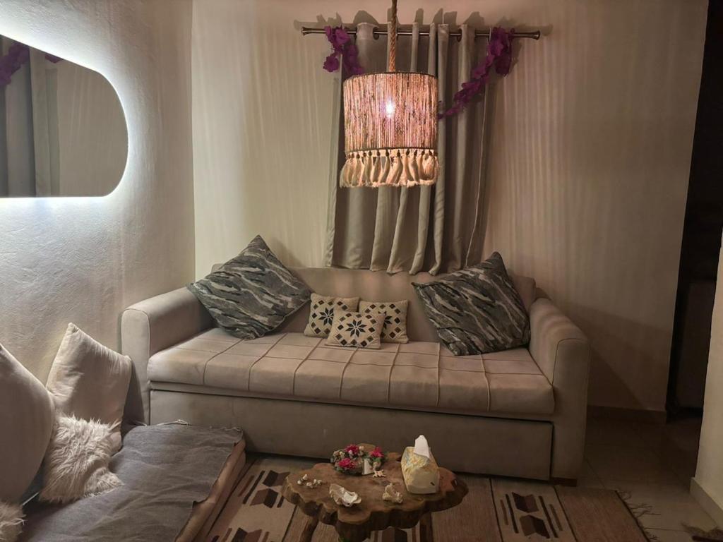 a living room with a couch with pillows on it at Fresco in Dahab