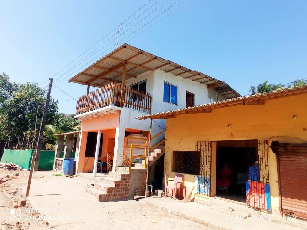 a house under construction with a balcony at Omkar Homestay Adgaon Beach Sea View Next to Diveagar 2 in Adgaon