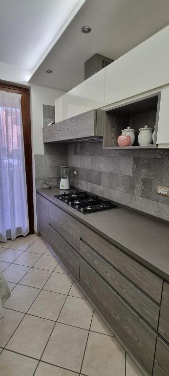 een keuken met een aanrecht met een fornuis. bij Luminoso e accogliente in Cortona