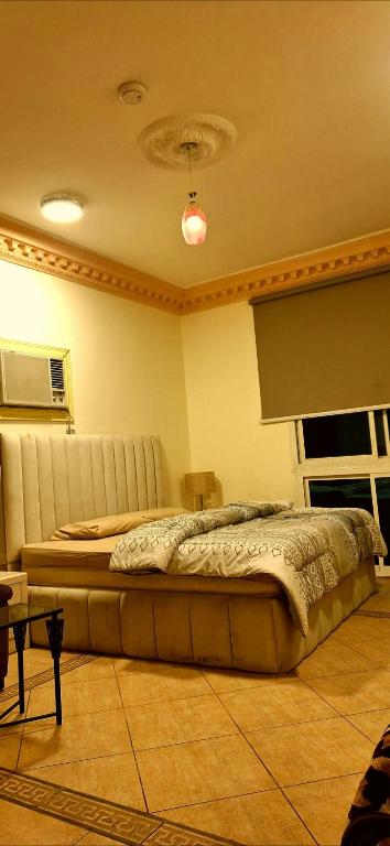 a bedroom with a large bed in a room at Sharif Apartments in Medina