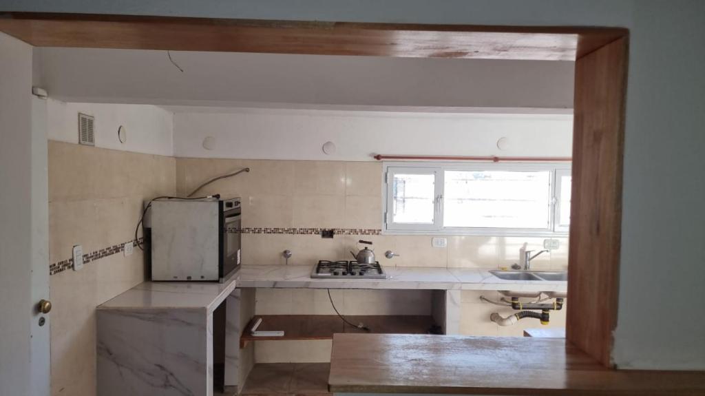 a small kitchen with a sink and a refrigerator at El Solar in San Antonio Oeste