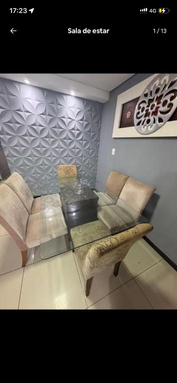 a living room with a glass table and a couch at My House in Itajaí