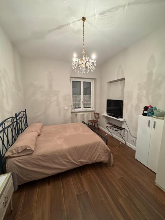 een slaapkamer met een bed en een kroonluchter bij Ai Cappuccini in Tricarico