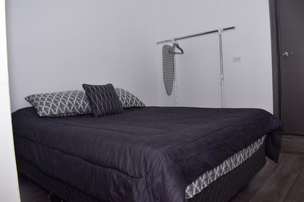 En eller flere senge i et værelse på Departamento LUNA