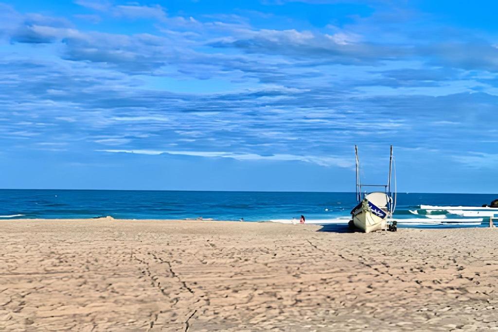 een boot op een zandstrand in de buurt van de oceaan bij Cantinho Perfeito Em Matinhos in Matinhos