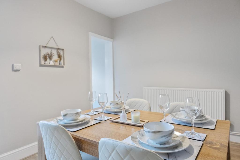a dining room with a wooden table and chairs at 12 osbourne road in Gillingham