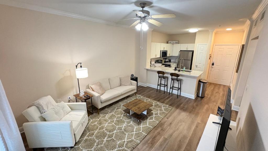 a living room with a couch and a table at Relaxing Pool-View 1BR Near Top Houston Spots in Houston