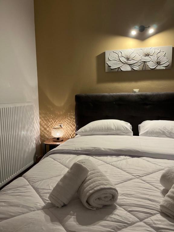 a bedroom with a bed with towels on it at Onar Apartments in Kalavrita