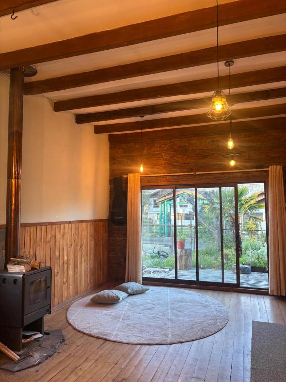 a room with a large round bed in a room with a window at Hostal Celta in Pucón
