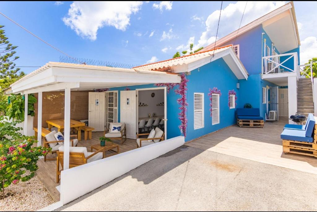 a blue and white house with a patio at Something Els in Willemstad