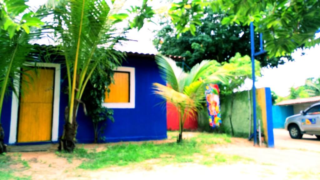 a small house with colorful paint on the side of it at casa n 3 jeri in Jericoacoara