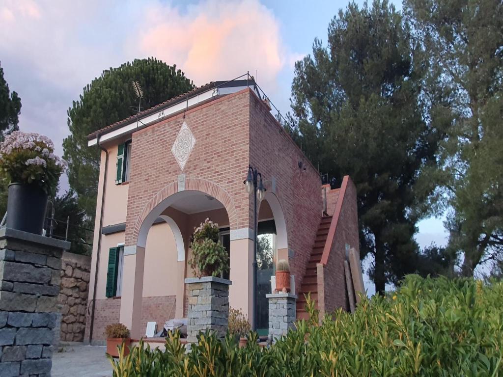 a brick building with an arch in front of it at Poolside Apartment in Italian Villa in San Lorenzo al Mare
