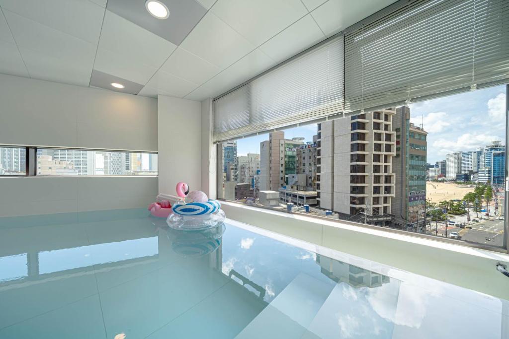 a swimming pool with a view of a city at The Moor in Busan