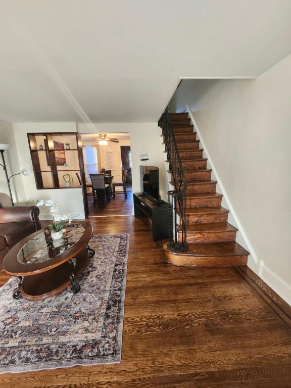 een woonkamer met een trap en een tafel bij Lansdowne Gem in Lansdowne